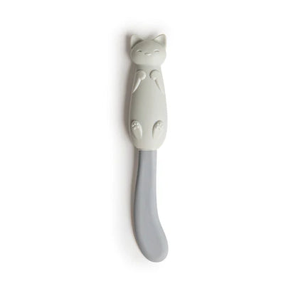 Cat-shaped ceramic spoon rest on a white background