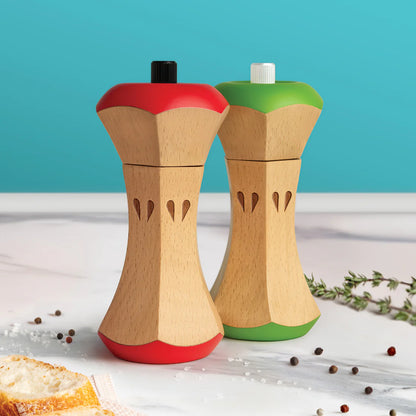 Wooden salt and pepper shakers shaped like apples with colorful tops on a white surface.